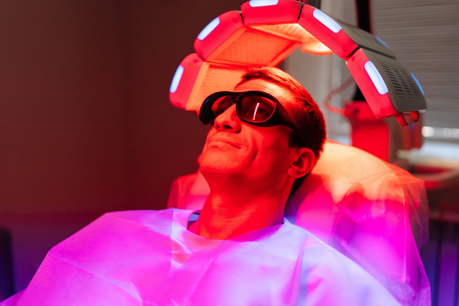 LLLT vs LED Light Therapy, man getting light therapy done to hair